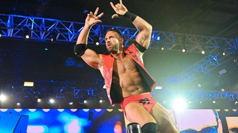 LA Knight poses in the corner for fans ahead of a match on 