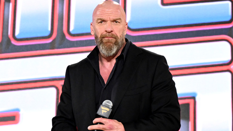 Triple H holding a microphone