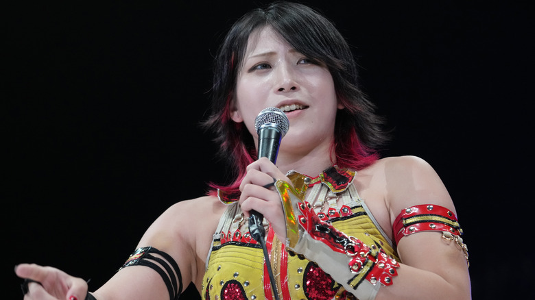 Hayashishita with a microphone in ring
