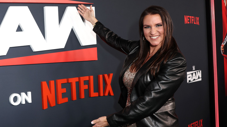 Stephanie McMahon poses next to the Netflix logo