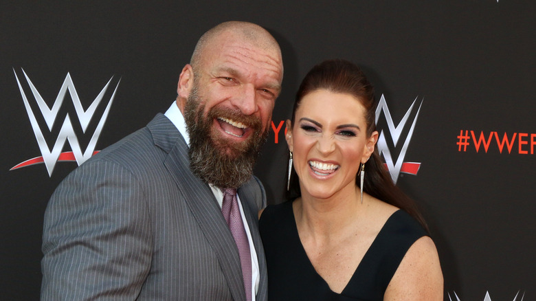 Stephanie McMahon and Triple H laughing