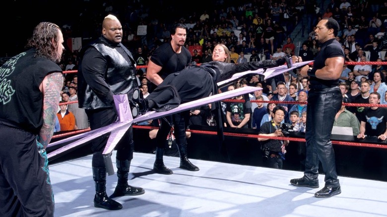 Stephanie McMahon being carried by the Ministry of Darkness
