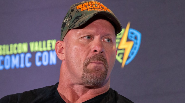 Steve Austin looks at someone next to him