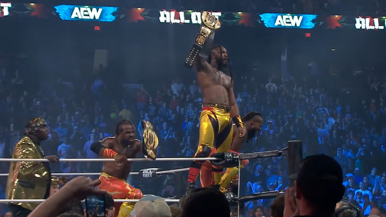 Swerve Strickland and New Level celebrate with the Trios titles