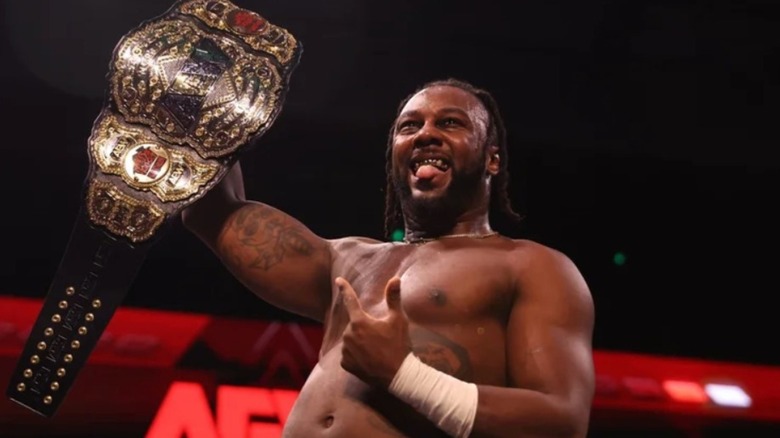 Swerve Strickland holds the AEW World Championship in the corner during an episode of AEW TV.