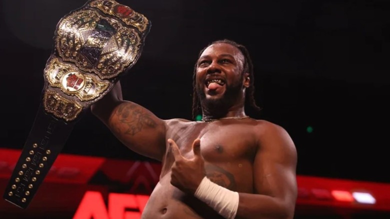 AEW World Champion Swerve Strickland holds up the title belt after a win on AEW television.