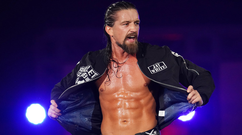 Before a match, Jay White poses on the second rope