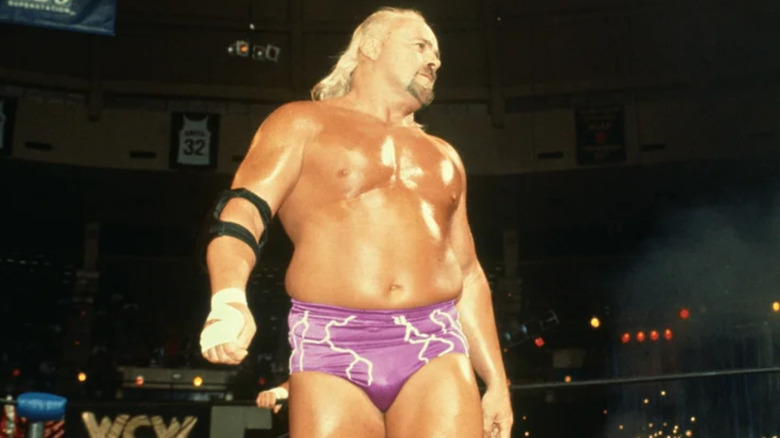 Kevin Sullivan wearing purple wrestling trunks