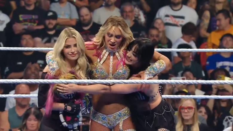 Charlotte Flair celebrates with Tatum Paxley and Alexa Bliss