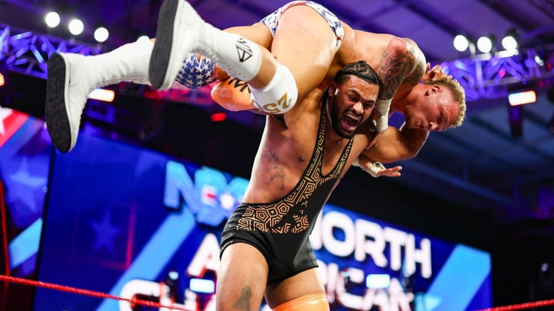 Tavion Heights puts North American Champion Myles Borne on his shoulders for a move during a match at 