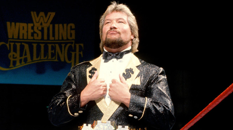 Ted DiBiase standing in a wrestling ring