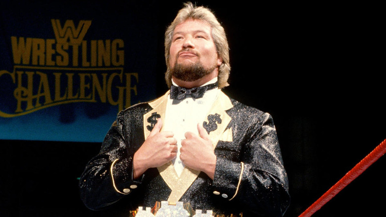 "The Million Dollar Man" Ted DiBiase grips his lapels with a haughty expression