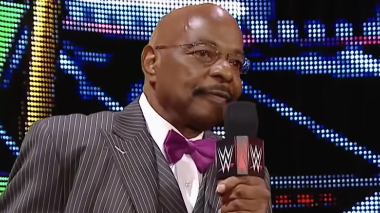 Teddy Long holding a microphone