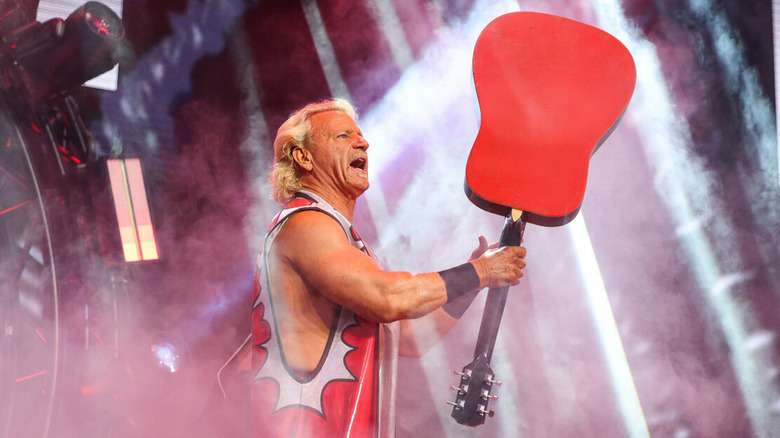 Jeff Jarrett holding his guitar