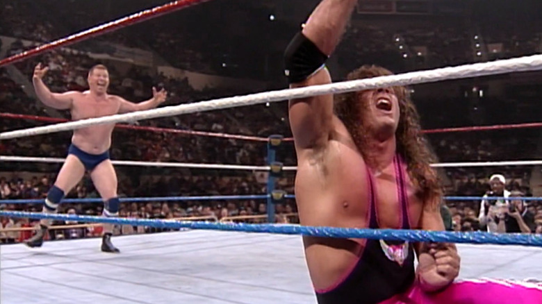 Bob Backlund taunts Bret Hart from behind