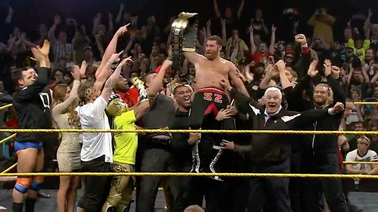 Zayn being held up after his championship win