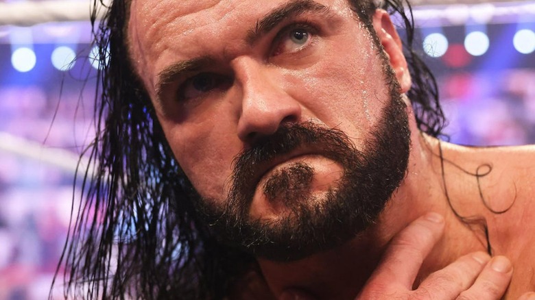 Drew McIntyre holds throat