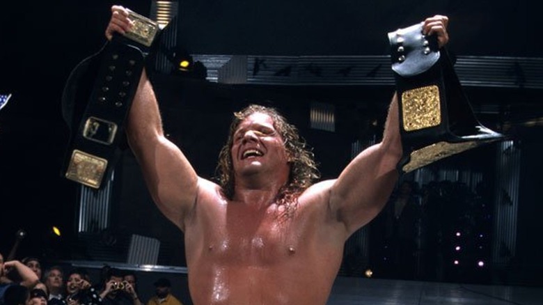 Chris Jericho hoists up WWE and World Championships