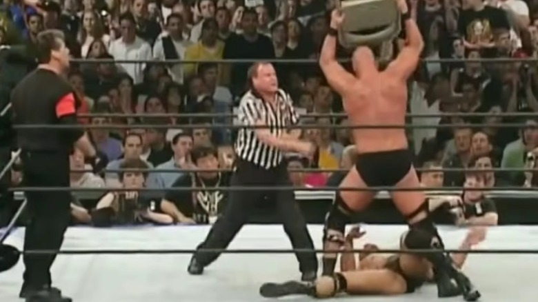 Steve Austin hits The Rock with a chair