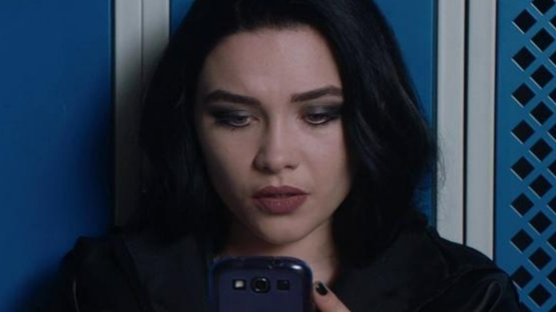 Florence Pugh looks at phone