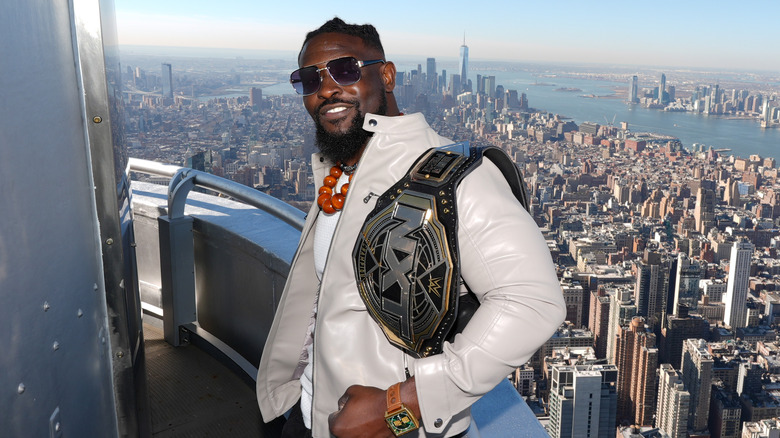 Oba Femi poses above New York City with the NXT Title