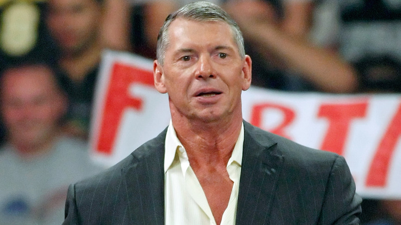 Vince McMahon wearing a suit in front of a crowd