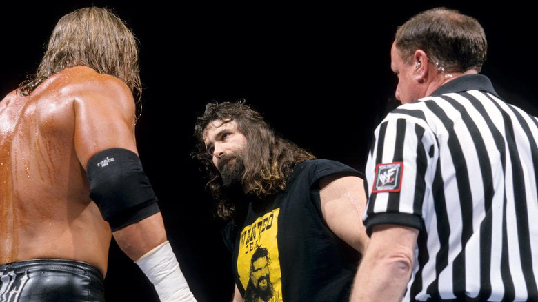 Cactus Jack looks at Triple H