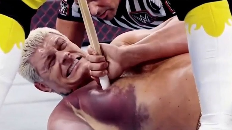 Seth Rollins pushes kendo stick into Cody Rhodes
