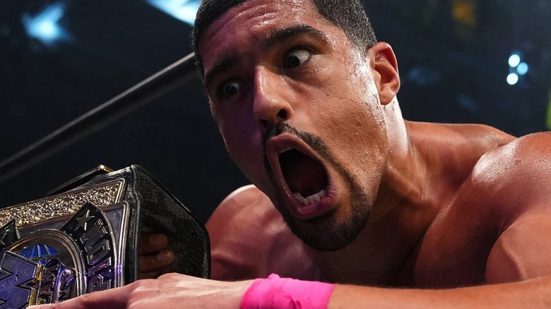 Anthony Bowens yelling while holding the AEW World Tag Team Championship