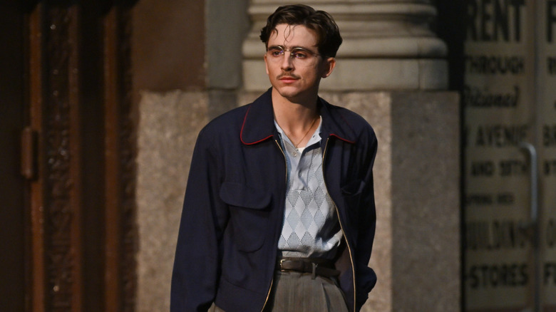 Timothee Chalamet stands on the set of "Marty Supreme"