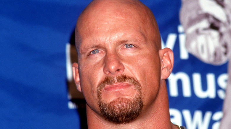 Medium close-up of Stone Cold Steve Austin in front of a blue background