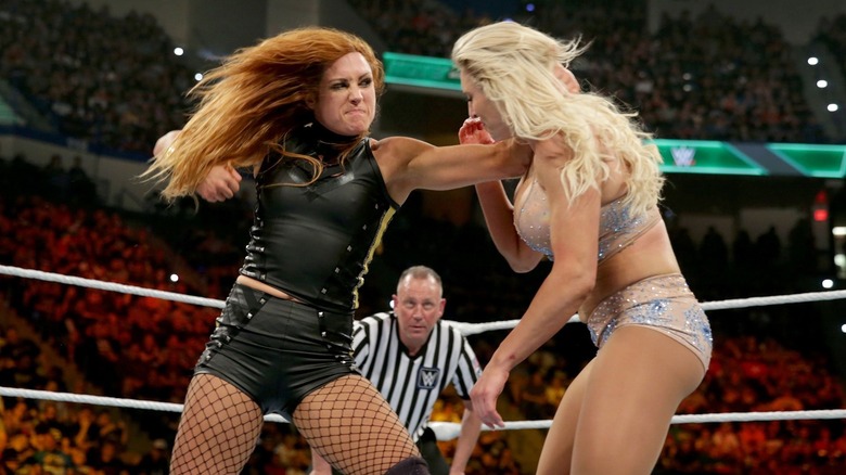 Becky Lynch and Charlotte Flair throw hands.