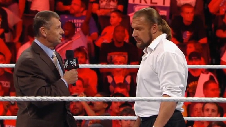 Vince McMahon addresses Triple H in the ring.