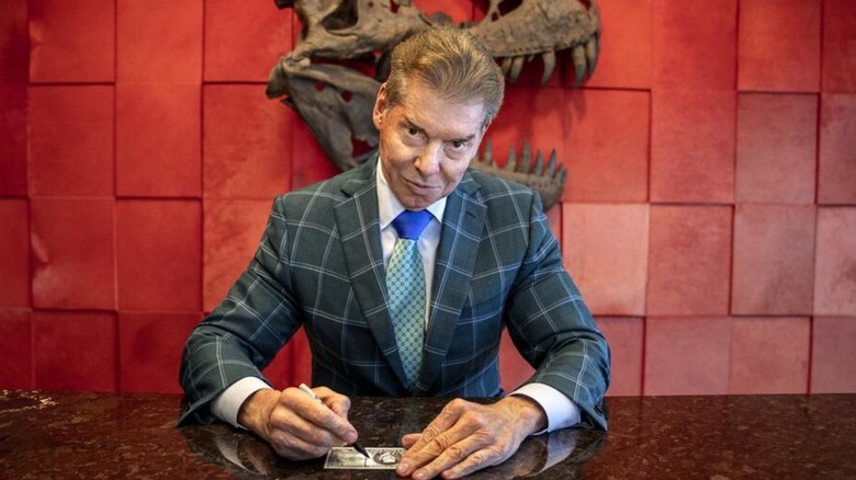 Vince McMahon signing a note