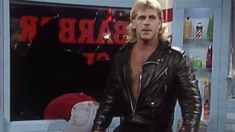 Jannetty hanging prone over the window