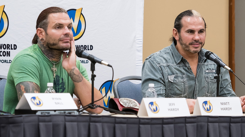 Jeff and Matt Hardy sitting in front of microphones