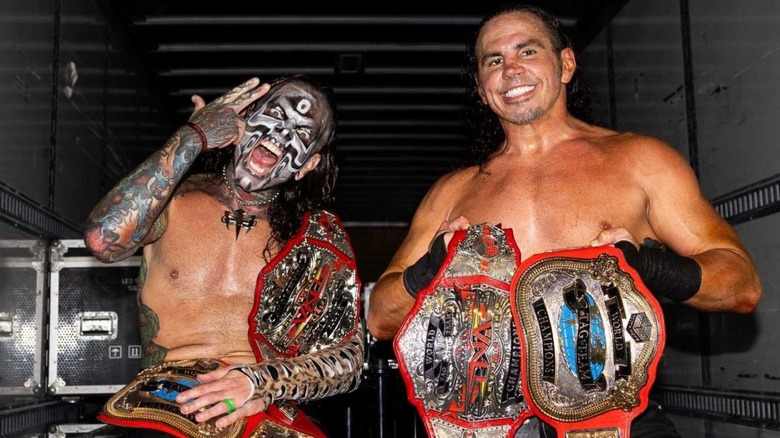 Matt and Jeff Hardy pose with the TNA Tag Team Championships backstage after a TNA show.