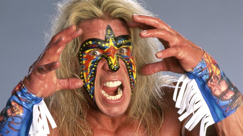 The Ultimate Warrior posing during a WWE photoshoot.