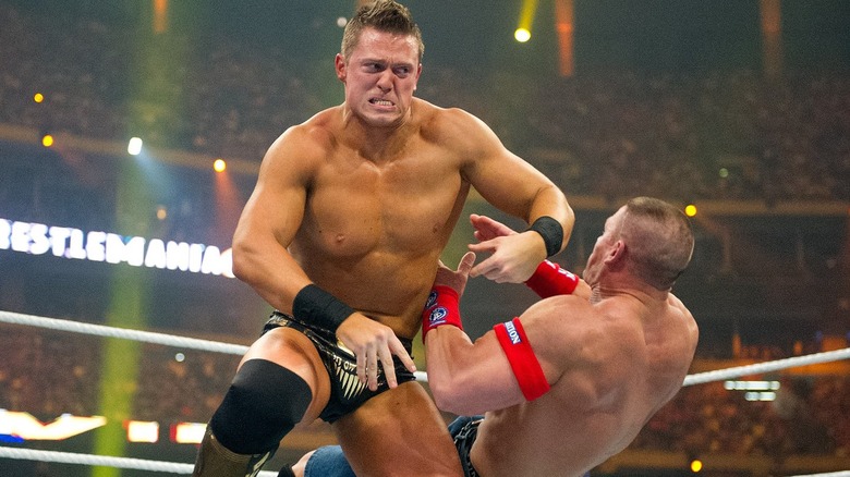 The Miz clashing with John Cena at WrestleMania XXVII during their main event match.
