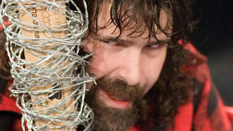 Mick Foley with a barbed wire baseball bat