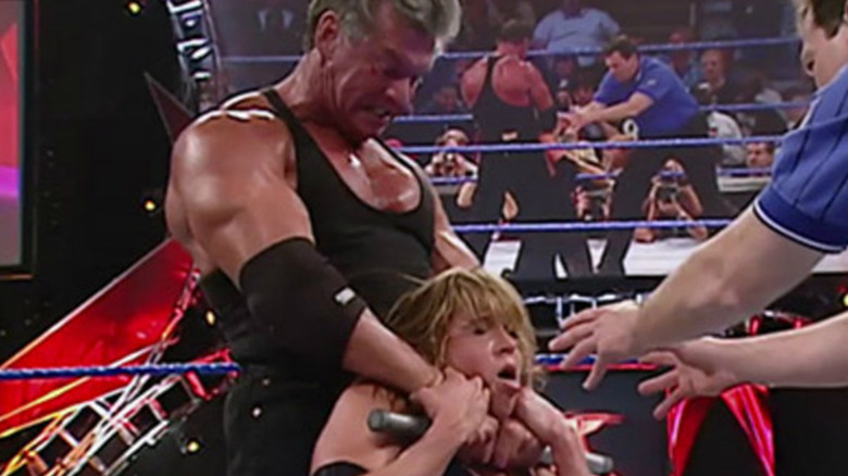 Vince choking Stephanie with a pipe