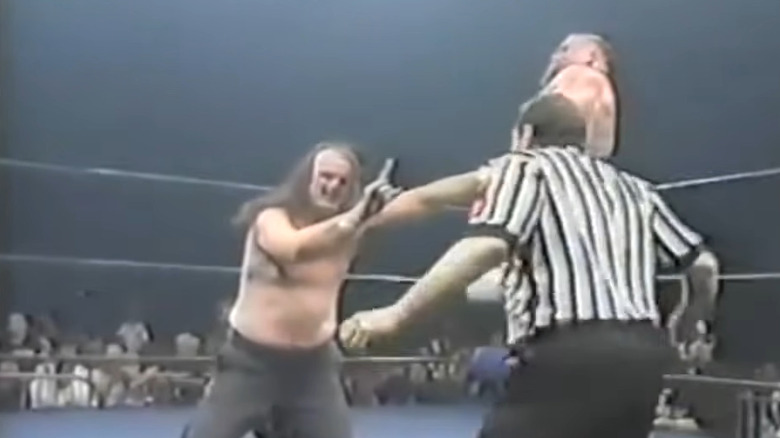 Jake The Snake Roberts holds up finger