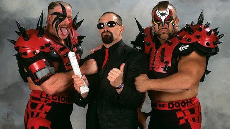 The Road Warriors pose alongside Paul Ellering.