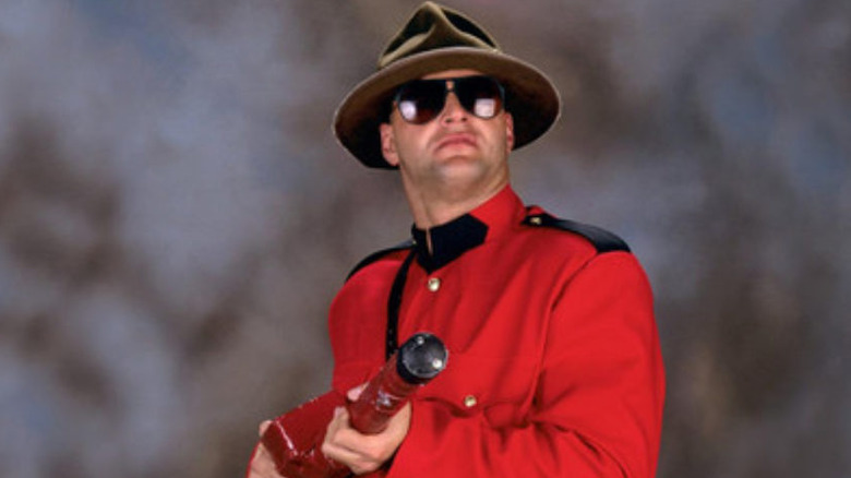 Jacques Rougeau holds baton