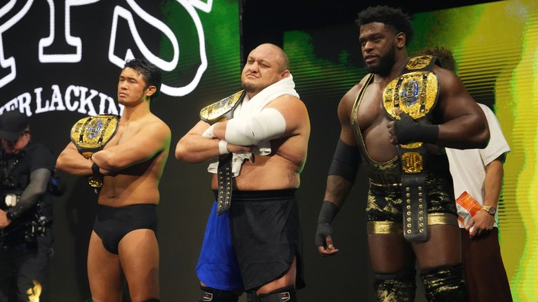 Katsuyori Shibata, Samoa Joe, and Powerhouse Hobbs holding the AEW Trios Championships