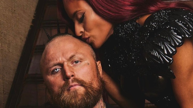 Zelina Vega kisses the top of Aleister Black's head in a photo posted to her X account.