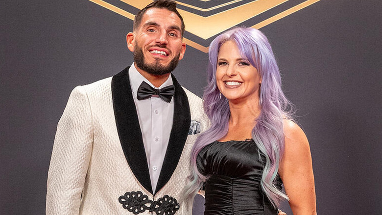 Candice LeRae and Johnny Gargano smile for the camera on the red carpet of the WWE Hall of Fame in 2025.