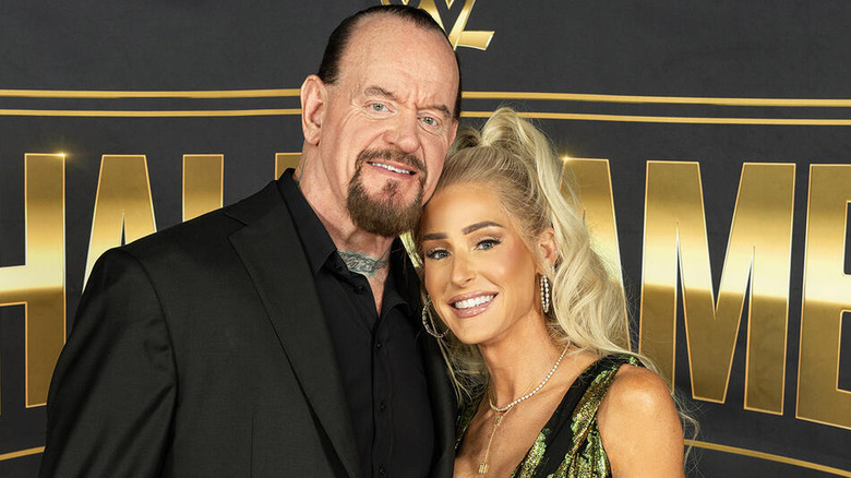 The Undertaker and Michelle McCool pose on the red carpet of the WWE Hall of Fame before McCool's induction.