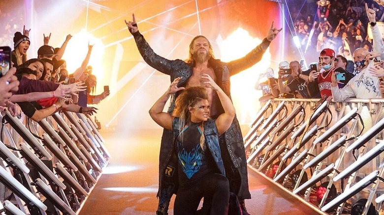 Edge and Beth Phoenix pose on the ramp during their entrance before a match at a WWE premium live event.