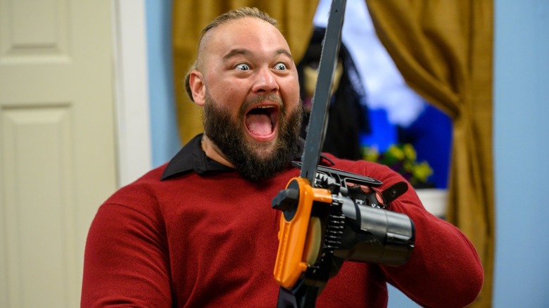 Bray Wyatt wields a chainsaw in the Firefly Fun House.